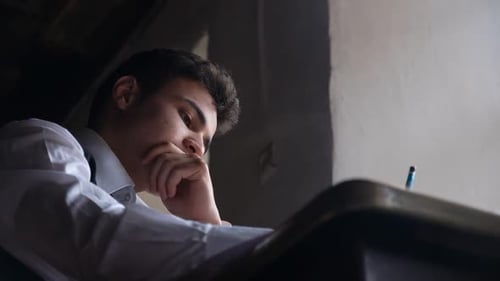 Young Adult Studying Indoors at Table