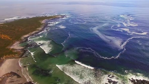 Aerial view of waves reaching a shore at beach