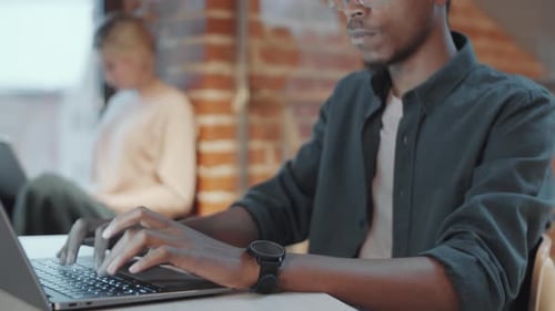 African American Man Typing on Laptop at Office Workplace