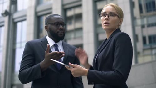 Business People Discussing Strategy Outside Building