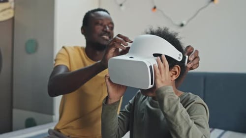 Son and Dad Using VR Goggles