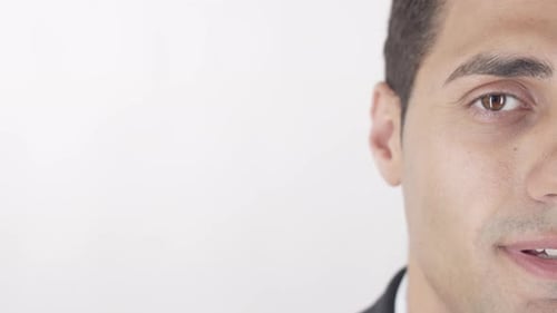 Man Opens Eyes and Smiles in Close Up