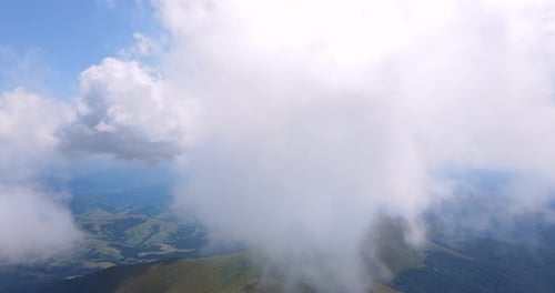 Scenic Aerial View of Green Mountains and Clouds