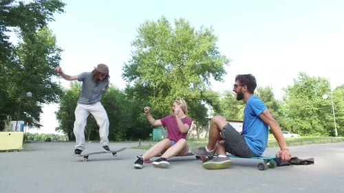 Friends Skateboarding Together in the Park on Sunny Day