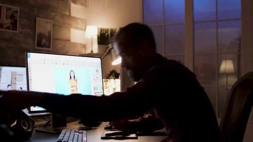 Bearded Man Photo Editing at Computer at Night