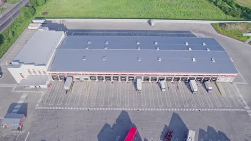 Aerial View of a Distribution Warehouse with Trucks