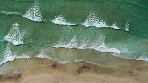 Top down view on the tropical sand Beach with Splashing Sea Waves,Norway