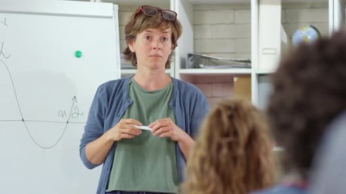 Teacher Giving Math Lesson in Classroom