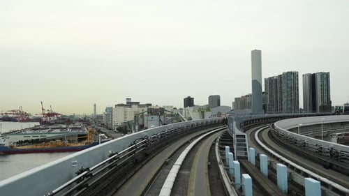Elevated Monorail Moving Through Urban Cityscape