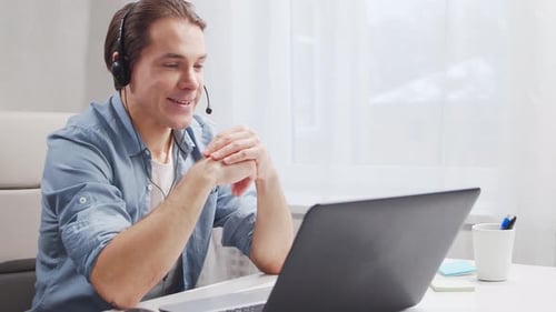 Workplace of freelance worker at home office. Young man works using computer.