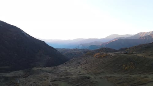 Winding trail in mountain valley at sunset