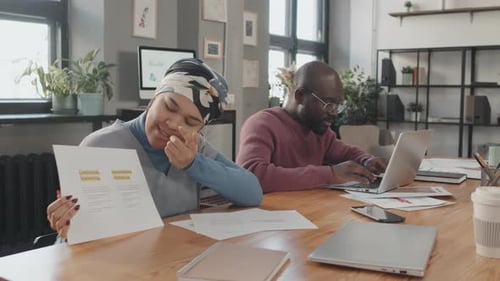 Business Colleagues Discuss Marketing Strategy in Office