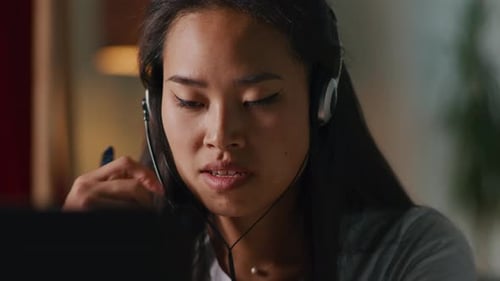 Young Woman Speaks into Headset Microphone at Work