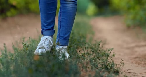 Legs Walking on Dirt Path in Rural Area