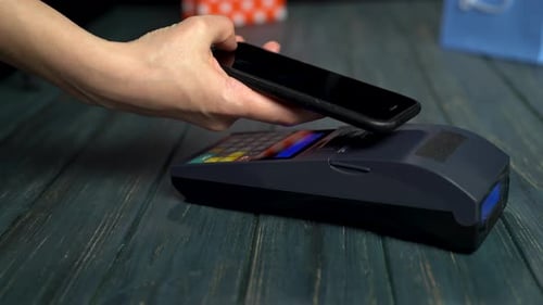 Paying with a Smartphone Device Wirelessly Over Credit Card Terminal. Video