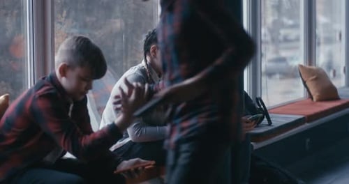 Students Using Smartphone in School Corridor