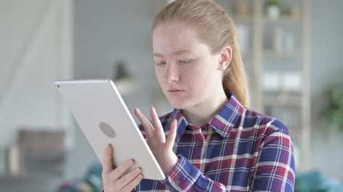 Young Woman Reacting to News on Tablet