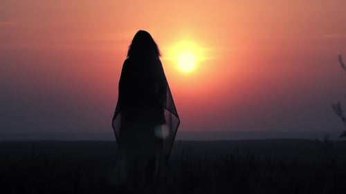 Woman Silhouette Reaching to Sky at Sunset