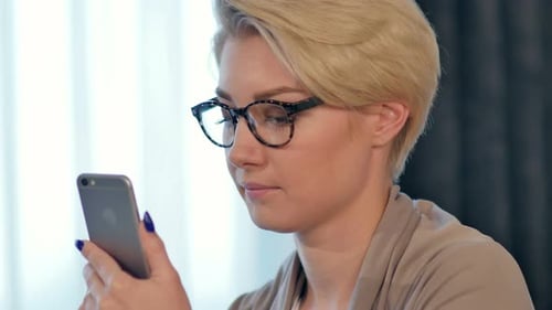 Woman with Glasses Using Smartphone Close Up