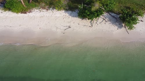 Beautiful sea waves and white sand beach in the tropical island.