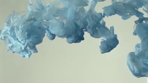 Light Blue Paint Plumes Dissolving in Water