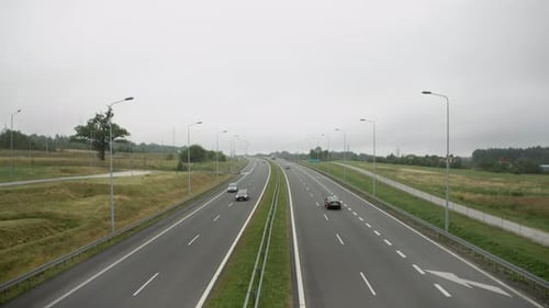 Highway With Passing Cars On A Rainy Day