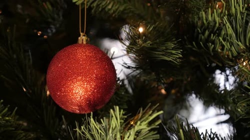 Decorative red ornament hanged on Christmas tree 4K 2160p 30fps UltraHD footage - Artificial branch