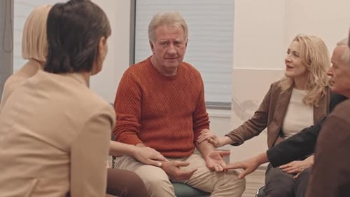 Supportive Therapy Session with Group Touching Arm