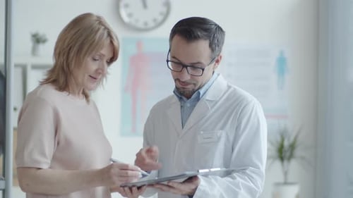 Doctor Consulting with Patient in Modern Medical Office