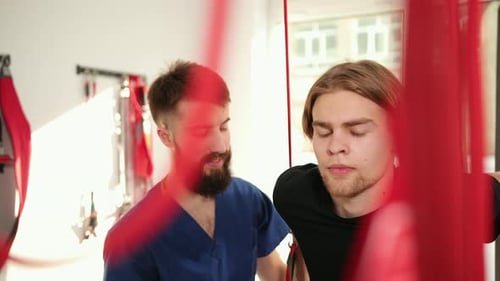 Young Adult Man Doing Physical Therapy with Assistance