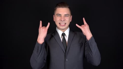 Man in Suit Making Rock Hand Gesture