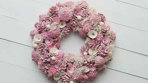 Elegant Pink Floral Wreath on White Wooden Surface