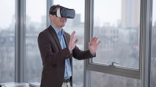 Man Using VR Headset in Modern Office Setting