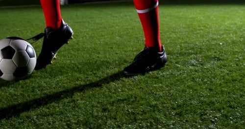 Low section of soccer player and ball on field 4k