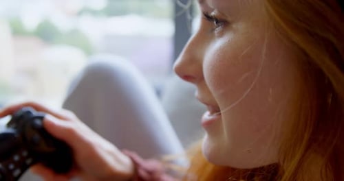 Woman Playing Video Game at Home, Close-Up