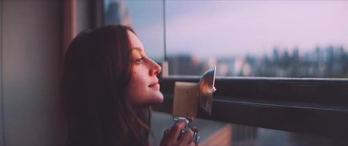 Woman Photographer with Vintage Camera at City Sunset