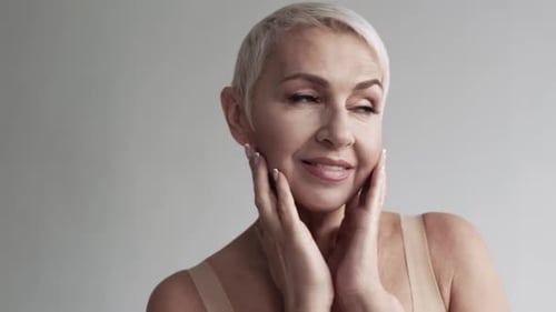 Beautiful Woman Smiling, Hands on Face in Close-Up