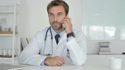 Doctor Talking on the Phone in Bright Office