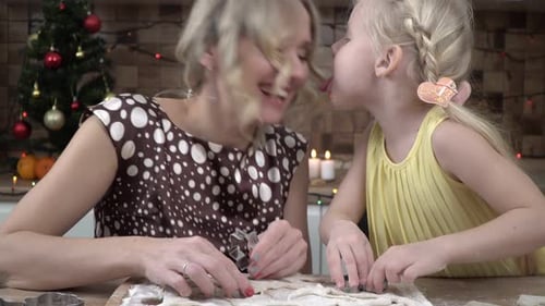 Happy Family Mom and Daughter are Preparing Cookies for Christmas in the Kitchen