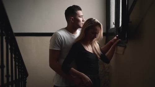 Loving Couple Embracing by the Window Indoors