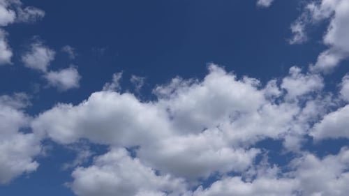 Fluffy White Clouds Against a Bright Blue Sky