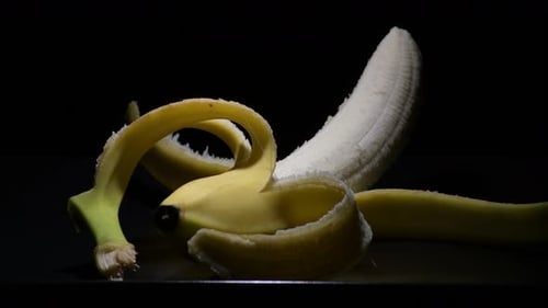 Peeled Banana Under Dark Lighting