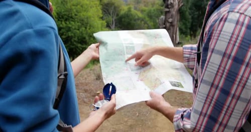 Hikers consult map in scenic mountain setting