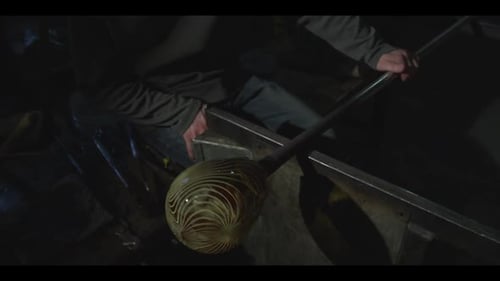 Glassblower Shaping Molten Glass with Skillful Precision