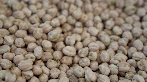 A Lot of Chickpeas on the Market Close-up. The Camera Moves. Slow Motion.