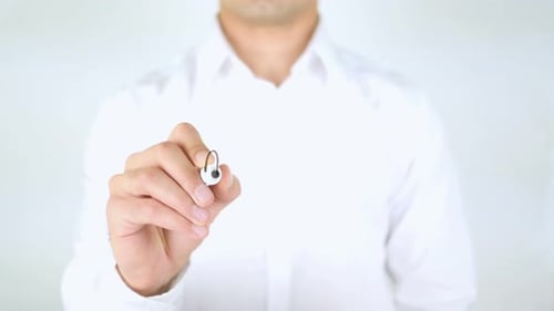 Man Writes Active on Clear Surface with Marker
