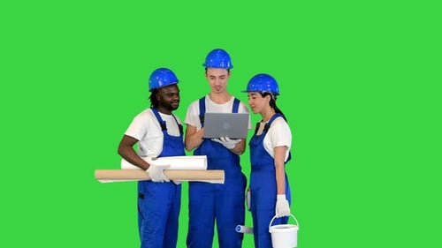 Multiethnic Diverse Team of Engineers Working on a Laptop on a Green Screen Chroma Key
