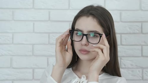Brunette Woman Adjusting Fashionable Glasses