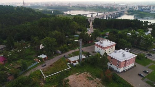 Small Houses On the Background of the Bridge and the City