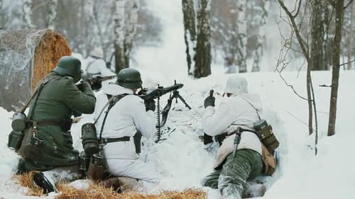Men Dressed As German Wehrmacht Infantry Soldiers In World War II Hidden Sitting With Weapon In An